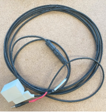 A black and red cable on a table

AI-generated content may be incorrect.