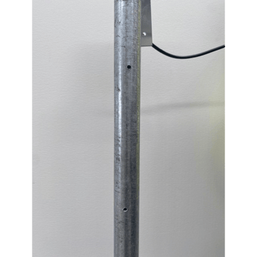 A metal pipe with a black wire

AI-generated content may be incorrect.