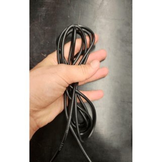 A hand holding a black wire