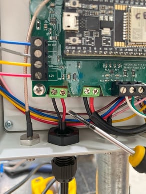 A circuit board with wires and screwdrivers

AI-generated content may be incorrect.